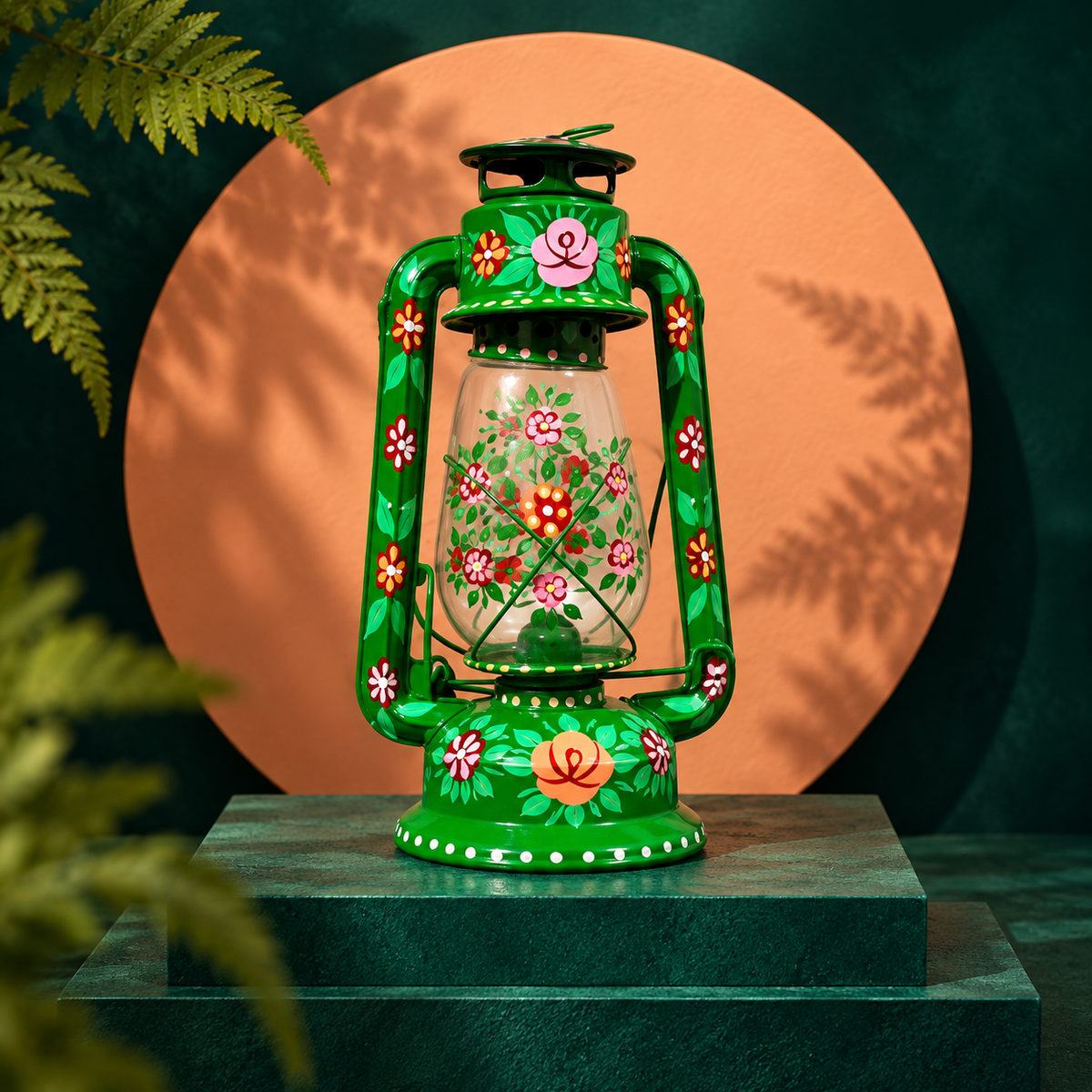 Hand-painted green floral lantern on an emerald pedestal against a terracotta circle