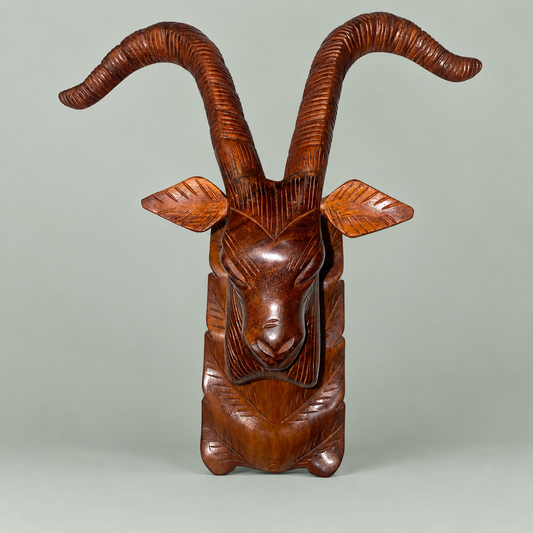 Hand-carved wooden ibex head wall décor with ridged curved horns, walnut finish