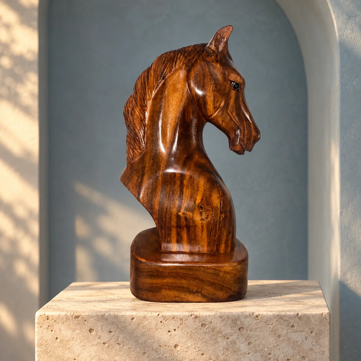 Carved wooden horse bust displayed in a gallery alcove